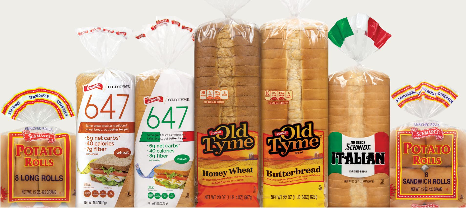 H&S Bakery bread in bags lined up: Schmidt 647 bread, Schmidt Old Tyme, Schmidt Italian Bread, and Schmidt's Potato rolls