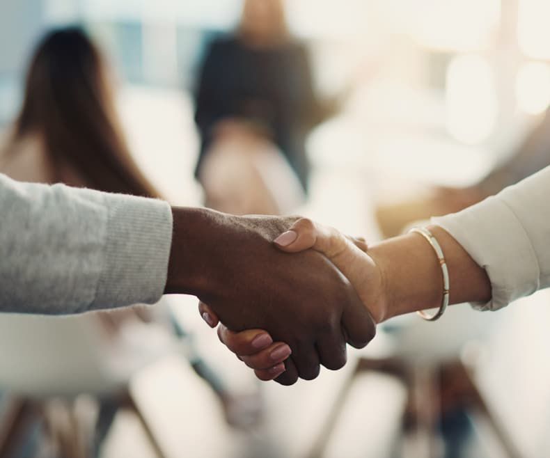 Two people shaking hands for an H&S Bakery job in Baltimore